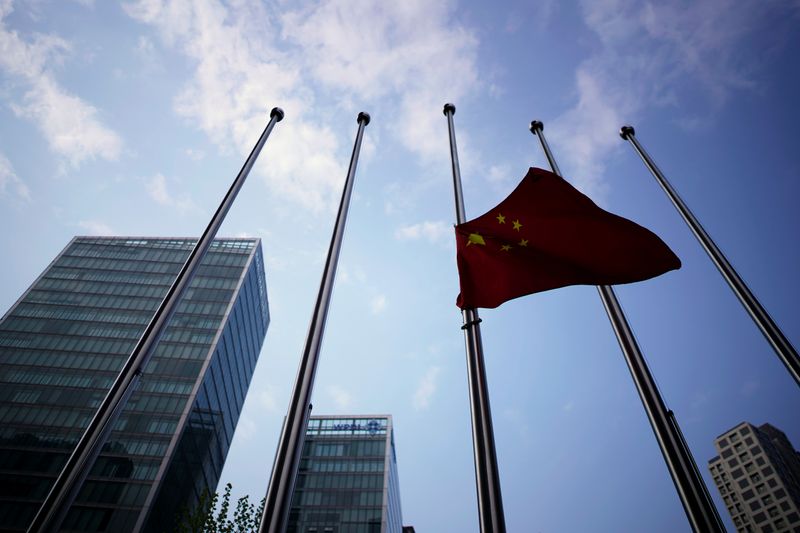 The Chinese national flag flies at half-mast near a hotel in Wuhan