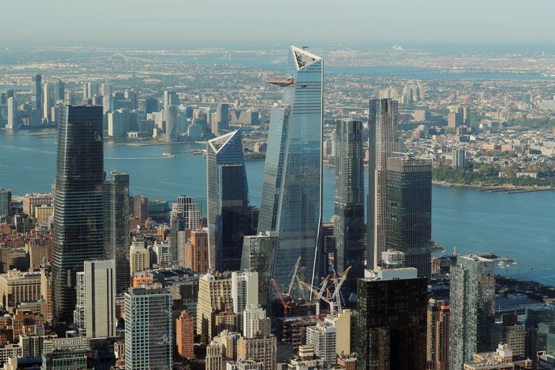 The buildings of Hudson Yards rise above lower Manhattan as seen from an apartment in the Central Park Tower building as the building celebrates its topping out in New York