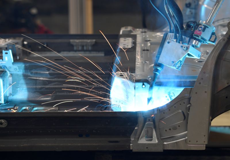 A robot welds car components in a production line at the Volkswagen plant in Wolfsburg