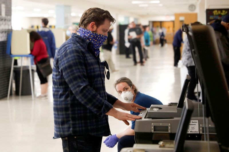 FILE PHOTO: Voters wait to cast ballots during the presidential primary election in Wisconsin