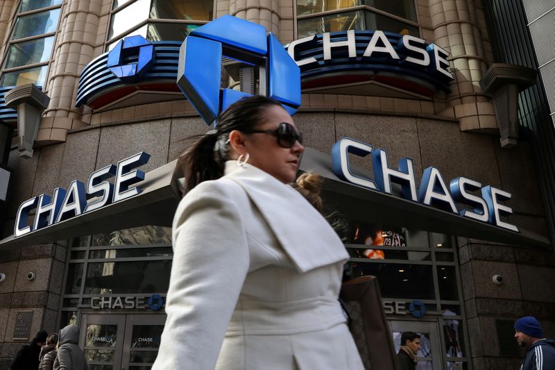 FILE PHOTO: A woman passes by a JPMorgan Chase bank in Times Square in New York