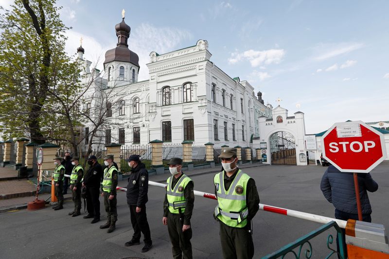 Ukrainian law enforcement officers stand guard at the entrance of the Kiev Pechersk Lavra monastery in Kiev