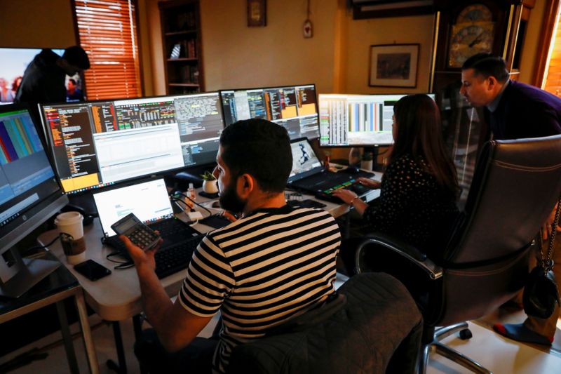 FILE PHOTO: NYSE-AMEX Options floor traders from TradeMas Inc. work in an off-site trading office due to the outbreak of the coronavirus disease (COVID-19), in New York