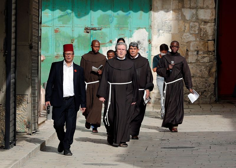Father Francesco Patton, the Custos of the Holy Land for the Roman Catholic church and other Franciscan Friars walk towards the Church of the Holy Sepluchre amid the coronavirus disease (COVID-19) outbreak in Jerusalem's Old City