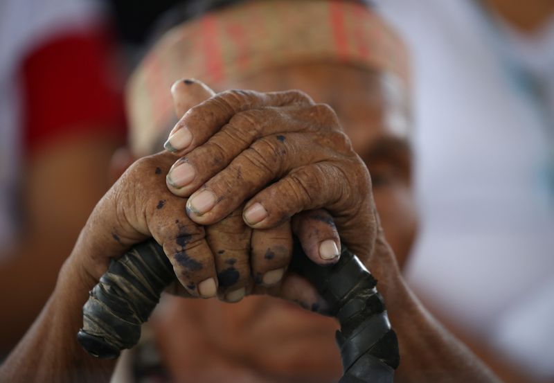 A member of an indigenous group from the Amazon region attend a meeting with Pope Francis at the Coliseo Regional Madre de Dios in Puerto Maldonado