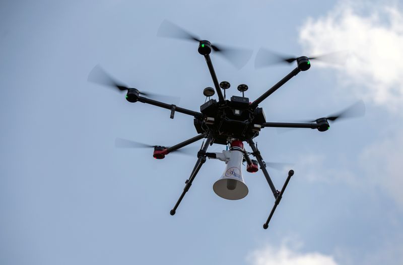 Rwandan police drone fitted with megaphone speaker flies in neighbourhood in Kigali