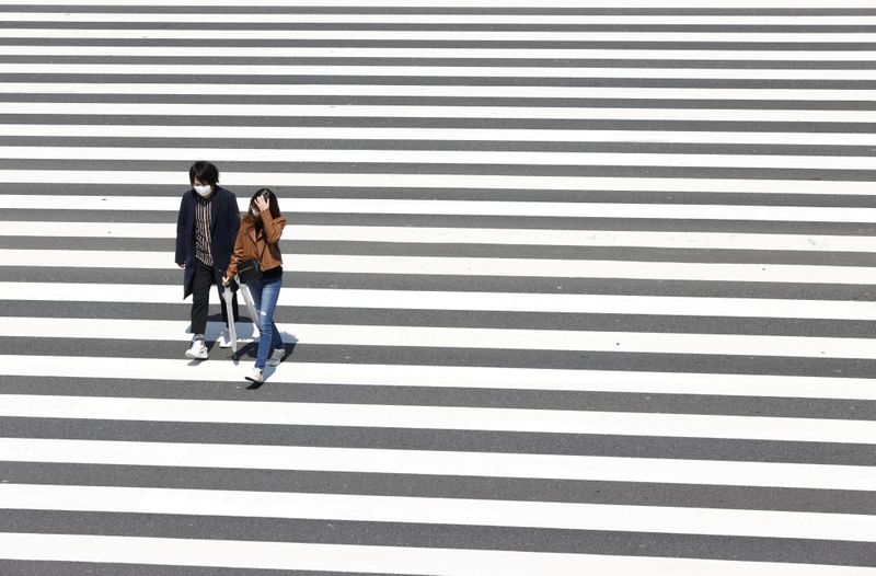 People walk on the crosswalk in Tokyo