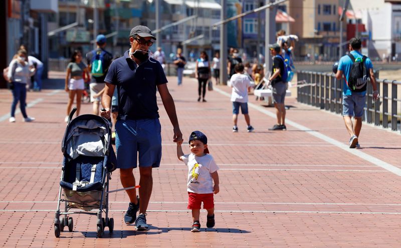 Children walk with their parents at promenade of Las Canteras beach after restrictions were partially lifted for children for the first time in six weeks, following the coronavirus disease (COVID-19) outbreak on the island of Gran Canaria