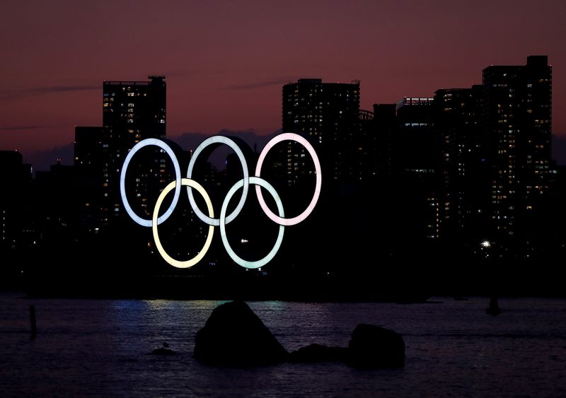 FILE PHOTO: The giant Olympic rings are seen in the dusk at the waterfront area at Odaiba Marine Park in Tokyo
