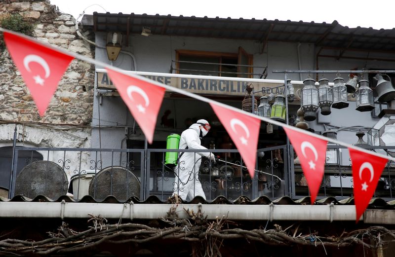 FILE PHOTO: A worker in a protective suit sprays disinfectant at Grand Bazaar, known as the Covered Bazaar, to prevent the spread of coronavirus