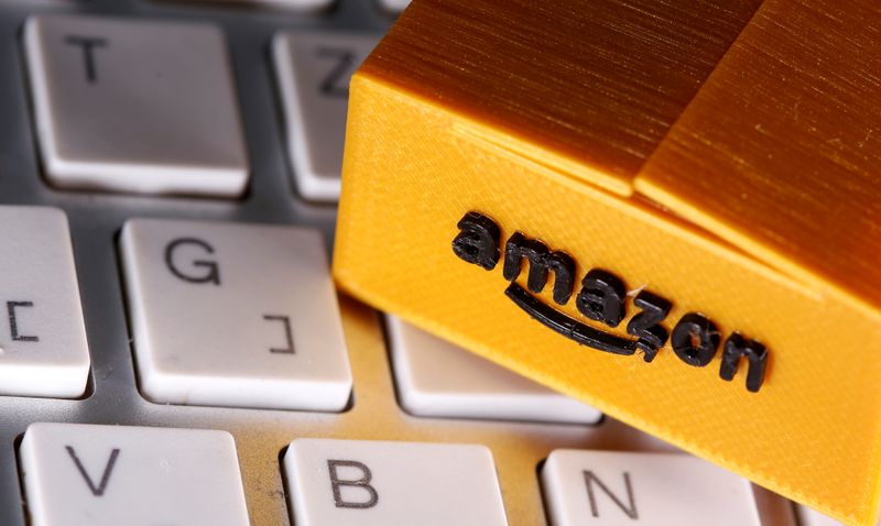 A 3D printed Amazon postal package is placed on a keyboard in this illustration taken