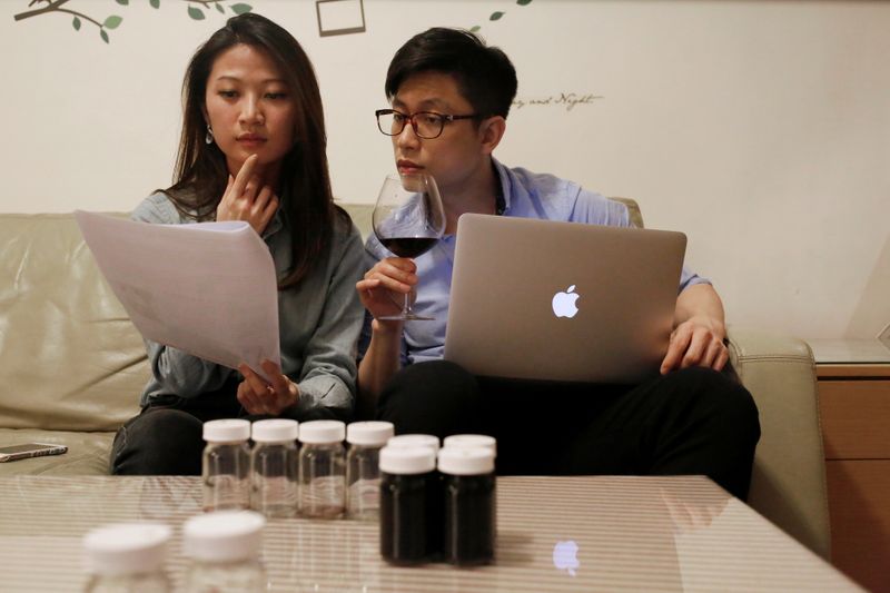 Participants attend an online wine tasting class at their home in Taipei