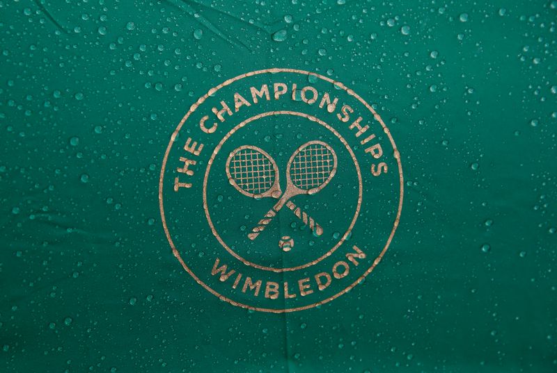 FILE PHOTO: Raindrops are seen on an umbrella at the Wimbledon Tennis Championships, in London