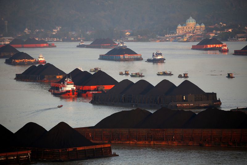 FILE PHOTO: Coal barges are pictured as they queue to be pull along Mahakam river in Samarinda, East Kalimantan province