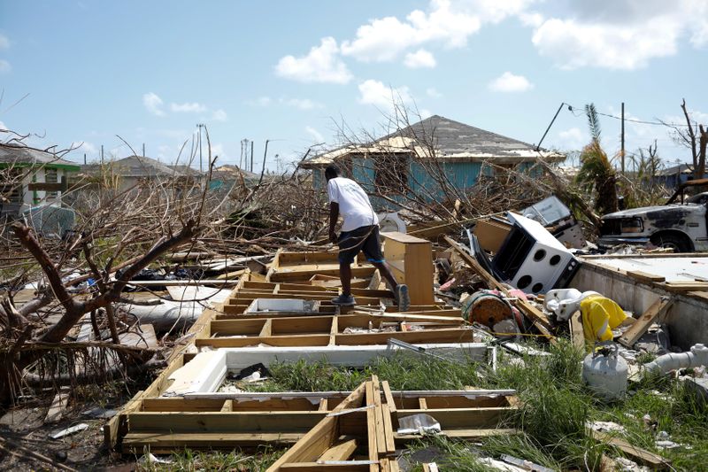 FILE PHOTO: A man walks among the debris of his house after Hurricane Dorian hit the Abaco Islands in Spring City