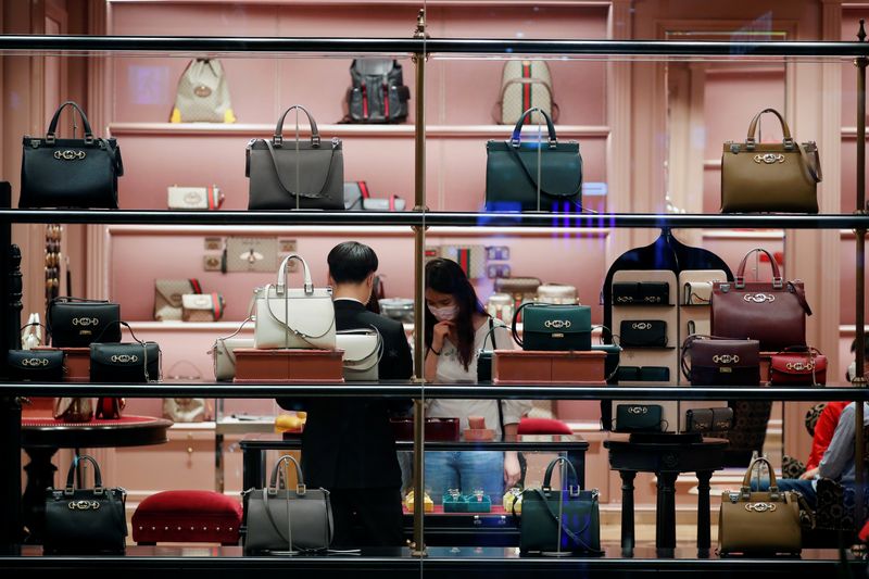 A woman wearing a mask to avoid the spread of the coronavirus disease (COVID-19) shops at a luxury shop in a department store in Seoul