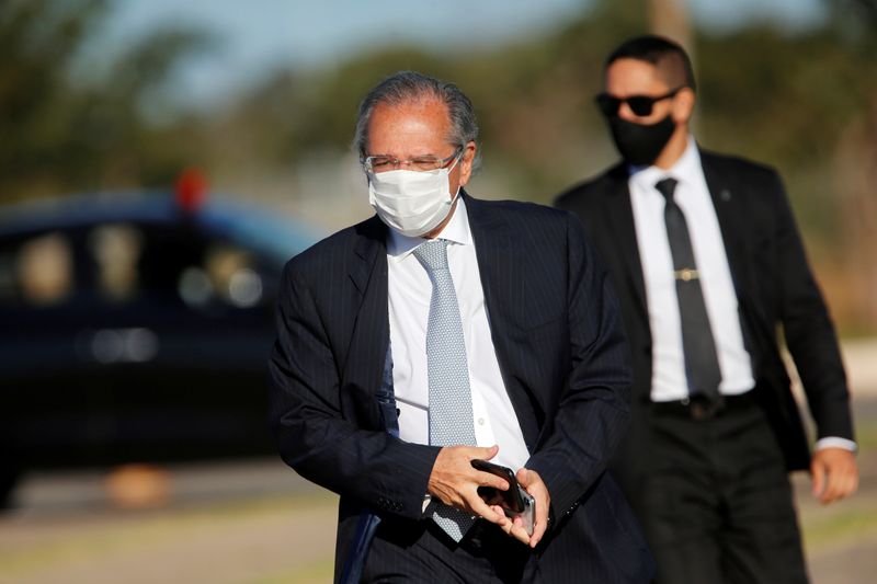 FILE PHOTO: Brazil's Economy Minister Paulo Guedes walks before a national flag hoisting ceremony in front the Alvorada Palace, amid the coronavirus disease (COVID-19) outbreak in Brasilia