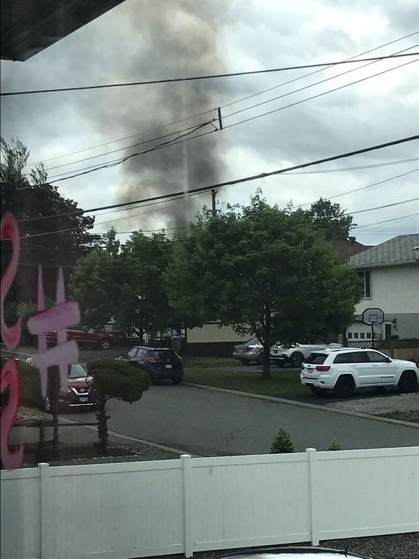 A plume of smoke rises over houses in Kamloops following a plane crash