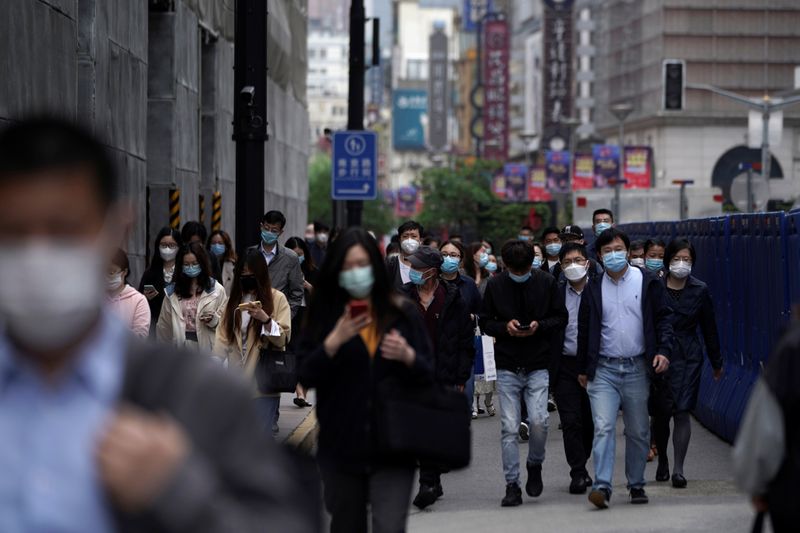 People wearing face masks walk at a main shopping area, following an outbreak of the novel coronavirus disease (COVID-19), in Shanghai