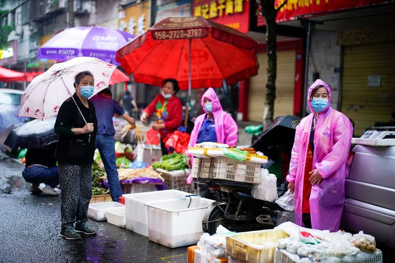 People wearing protective face masks are seen at a street market in Wuhan