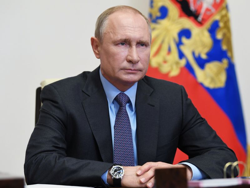 Russian President Vladimir Putin chairs a meeting via a video link outside Moscow