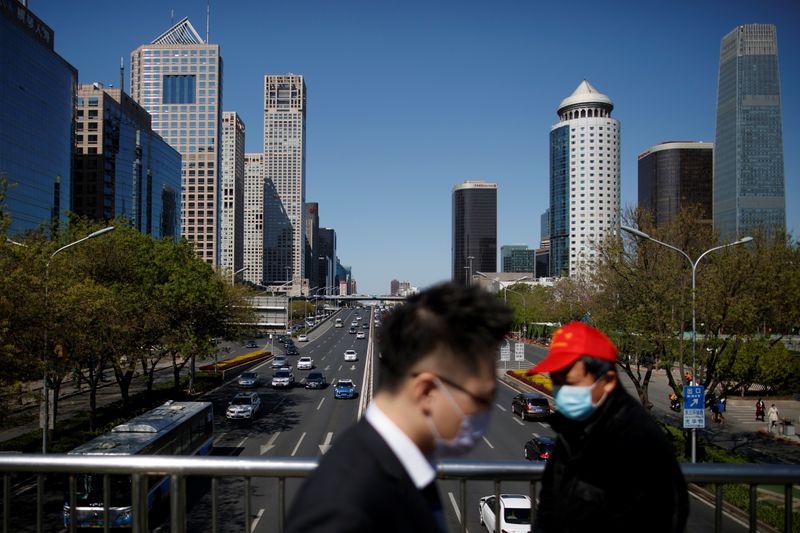 People wearing protective masks cross a bridge in the Central Business District on a “blue sky day