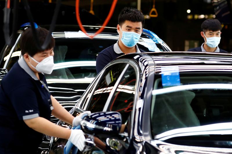 Employees wearing face masks work at a plant of Daimler-BAIC joint venture’s Beijing Benz Automotive Co during a government organised tour of the facility following the outbreak of the coronavirus disease (COVID-19), in Beijing