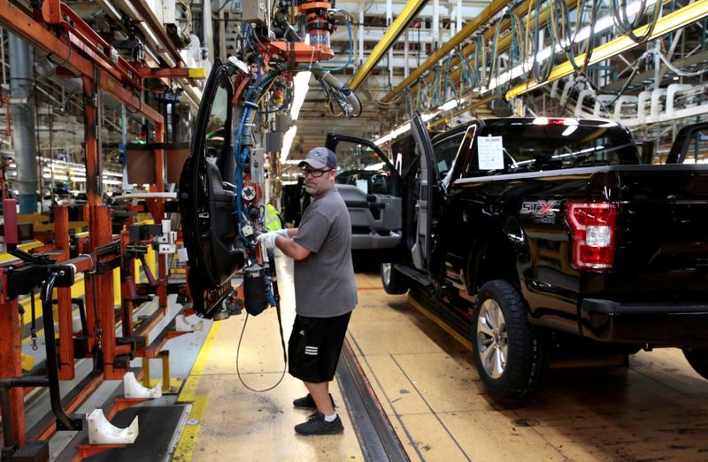 FILE PHOTO: A Ford Motor assembly worker works on a 2018 Ford F150 pick-up truck at Ford's Dearborn Truck Plant during the 100-year celebration of the Ford River Rouge Complex in Dearborn