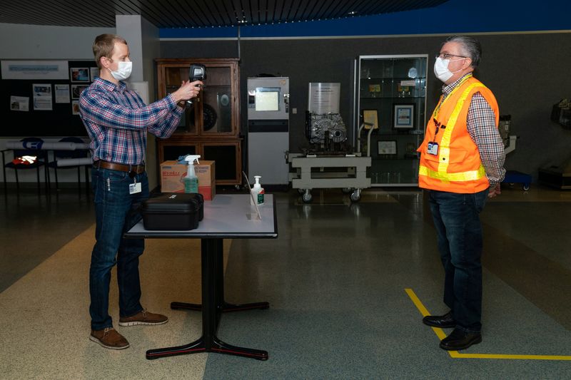 General Motors Co employees test a fever-scanning thermal camera from Flir Systems Inc at a facility in Warren
