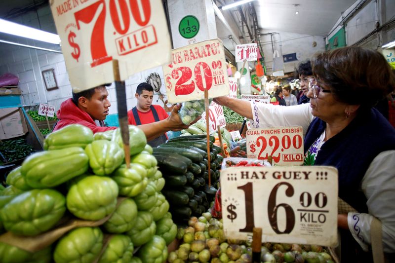 FILE PHOTO: A woman reaches for a bag of produce in the Central de Abastos wholesale market in Mexico City