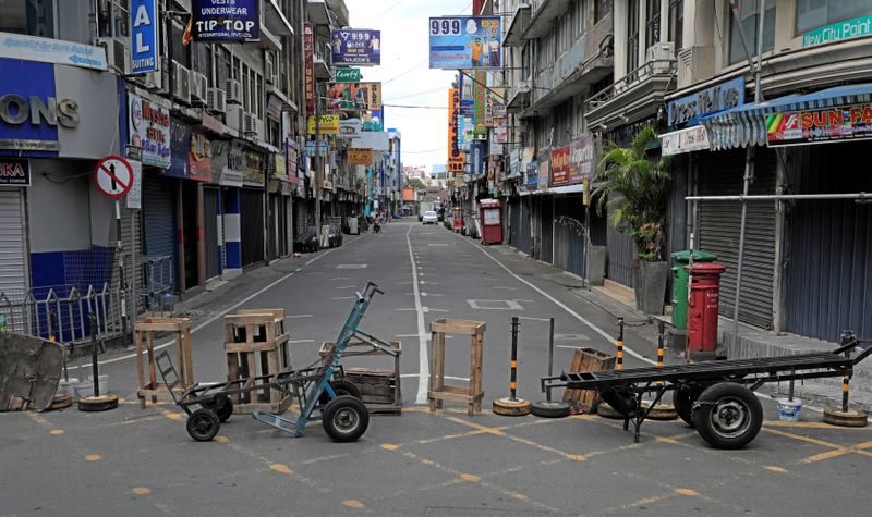 A temporary barrier to close a road where shops are closed is seen near the main market during a curfew amid concerns about the spread of coronavirus disease (COVID-19), in Colombo