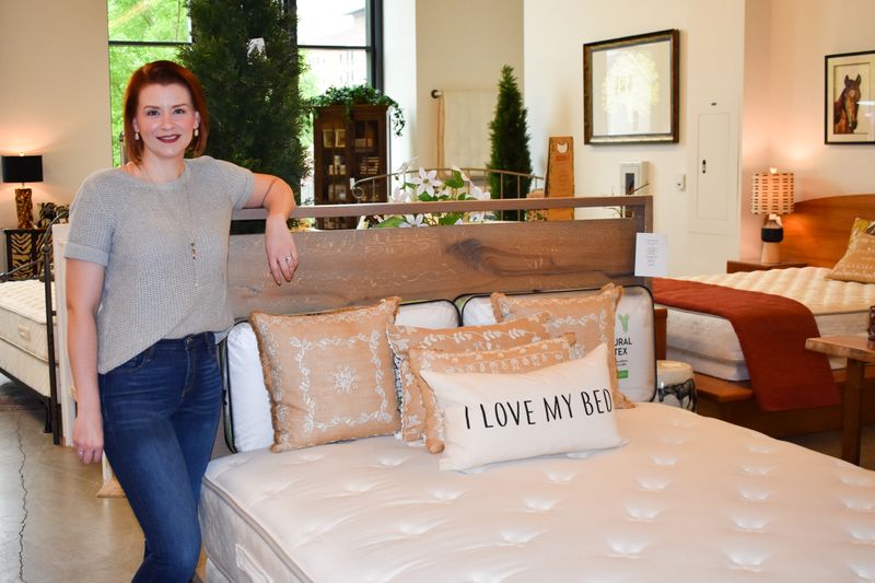 Lauren Taylor poses for a photo in a Holder Mattress store