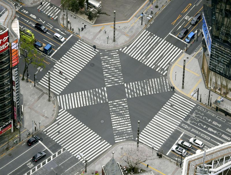 An aerial view shows less than usual passersby seen at a pedestrian crossing at Ginza district in Tokyo