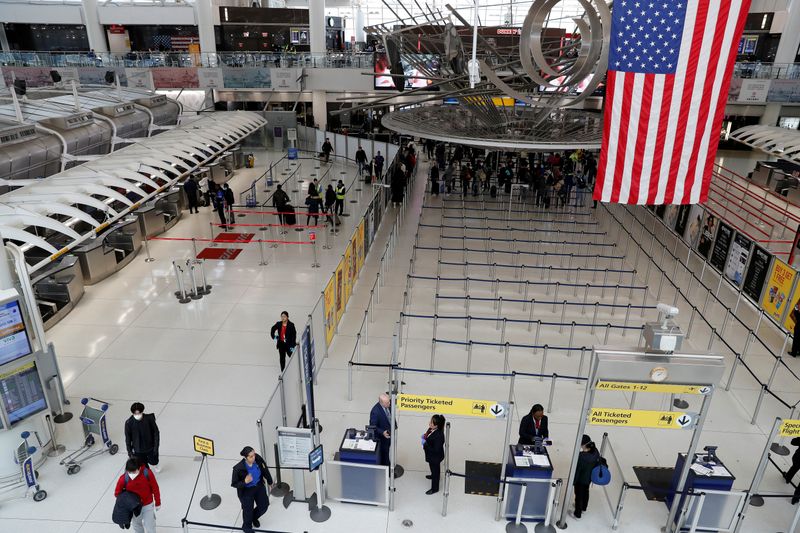 FILE PHOTO: Passengers walk through Terminal 1, after further cases of coronavirus were confirmed in New York, at JFK International Airport in New York