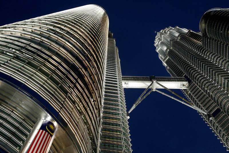 FILE PHOTO - Malaysia's flag is seen at the landmark Petronas Twin Towers in Kuala Lumpur