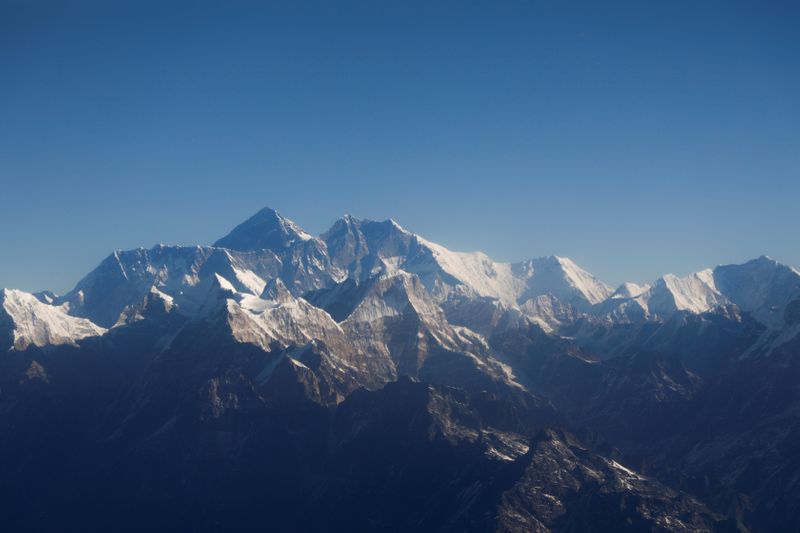 FILE PHOTO: Mount Everest, the world highest peak, and other peaks of the Himalayan range are seen through an aircraft window during a mountain flight from Kathmandu