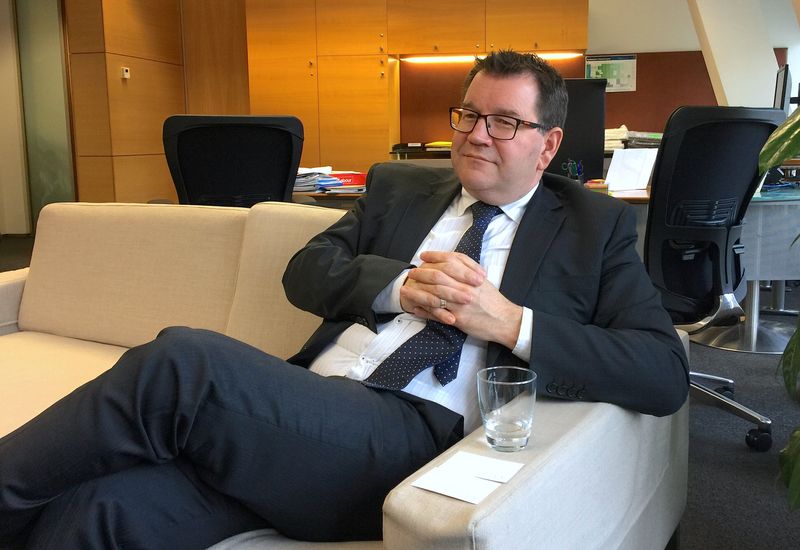 New Zealand's Finance Minister Grant Robertson listens to a question during an interview in his office in Wellington