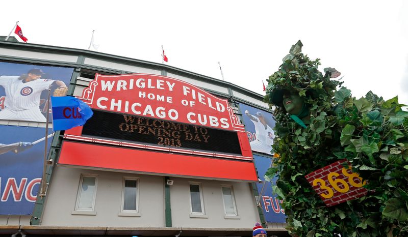 A fan dressed up as the Wrigley Field Center Field is seen outside the stadium prior to the Chicago Cubs' MLB National League baseball game home opener against the Milwaukee Brewers in Chicago