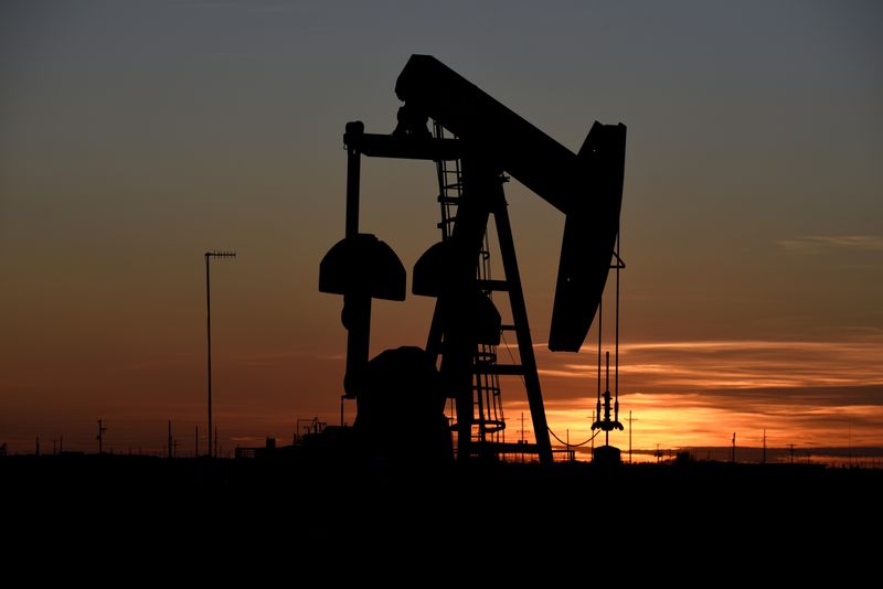 FILE PHOTO: A pump jack operates at sunset in an oil field in Midland