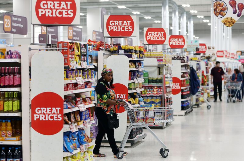 A shopper pushes a trolley in a supermarket in London
