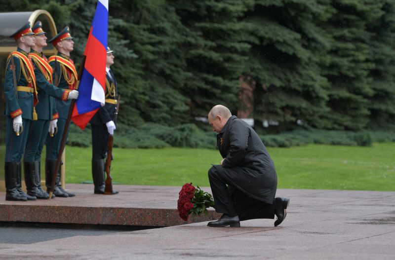 Russian President Vladimir Putin takes part in a flower-laying ceremony at the Tomb of the Unknown Soldier on Victory Day in central Moscow
