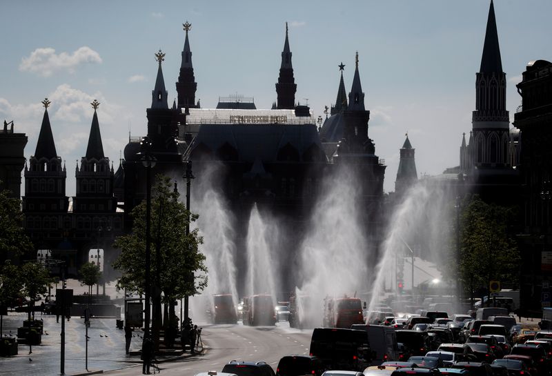 FILE PHOTO: Vehicles spray disinfectant while sanitizing a road amid the outbreak of the coronavirus disease in Moscow