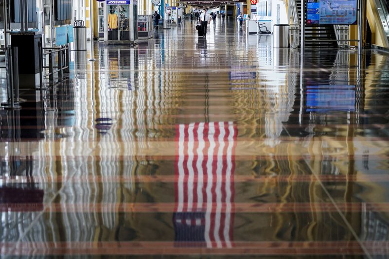 FILE PHOTO: An airline pilot walks through Reagan National Airport in Washington