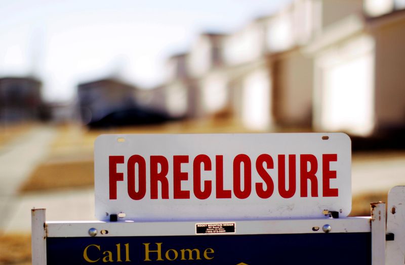 FILE PHOTO: The sign for a foreclosed house for sale sits at the property in Denver