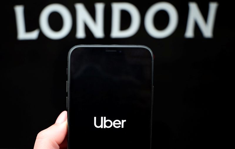 The Uber logo is displayed on a mobile phone in this picture illustration