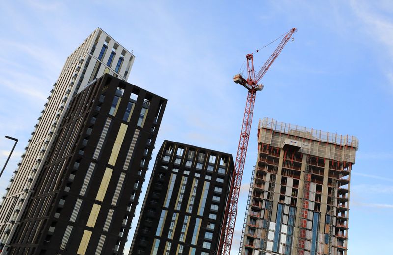 A crane is seen above some high rise building construction works at Lewisham, in London