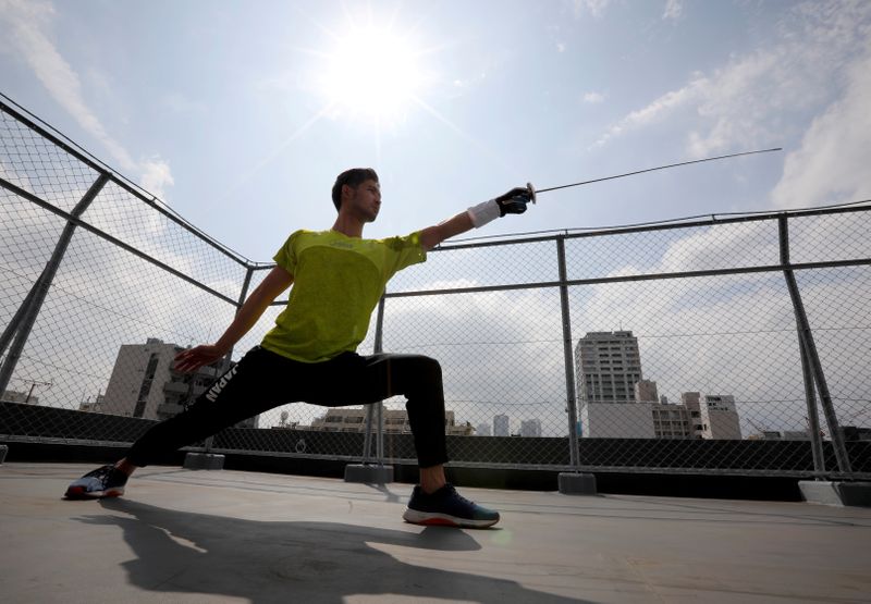 Japan's Olympic fencing medallist Ryo Miyake trains at the rooftop of his apartment in Tokyo