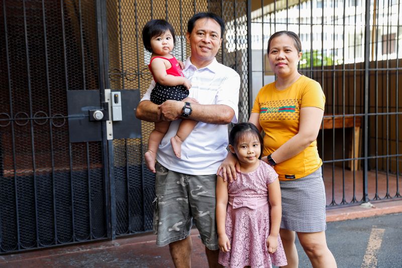 Judith and Jose Ramirez pose with their daughters outside their home in Honolulu