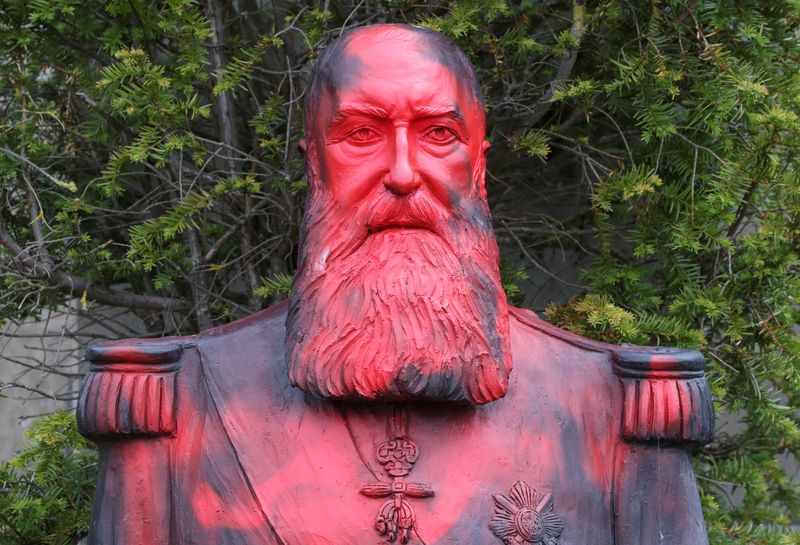 FILE PHOTO: A statue of former Belgian King Leopold II sprayed with a graffiti is seen in the park of the Africa Museum, in Tervuren