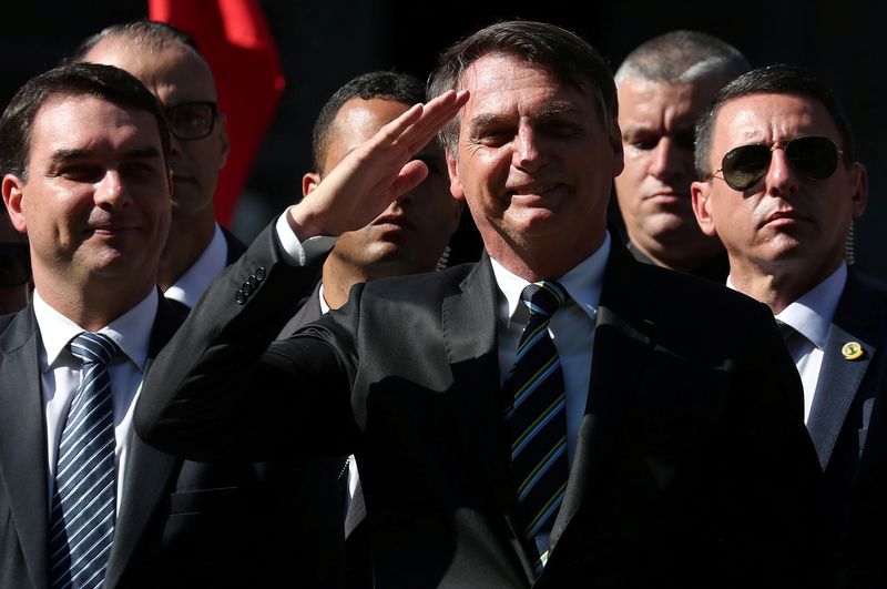 Brazilian President Jair Bolsonaro and his son and Senator Flavio Bolsonaro attend a ceremony to celebrate the 130th anniversary of the Military School in Rio de Janeiro